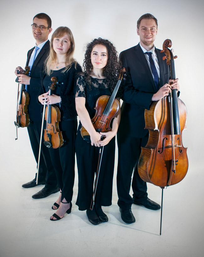 Four musicians in formal black holding string instruments: two violins, a viola, and a cello.